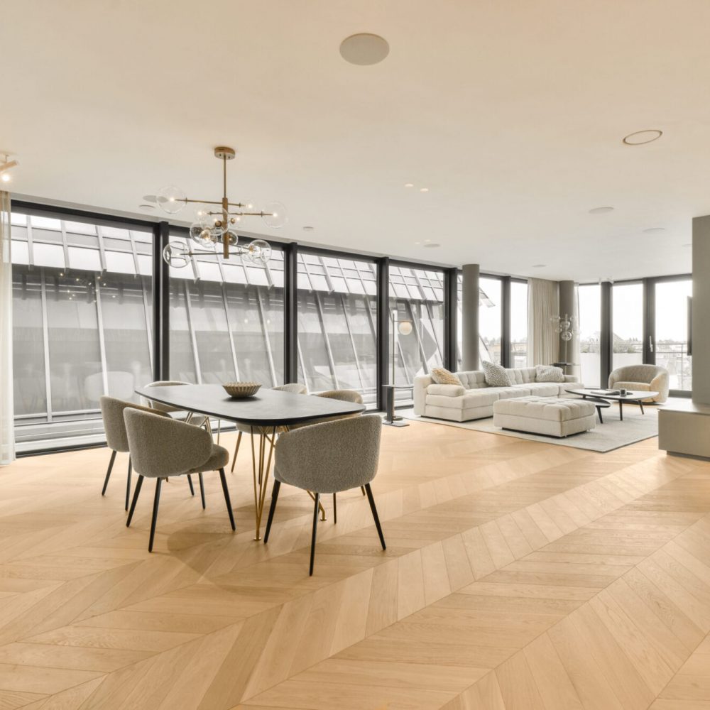 a living room with wood flooring and large windows looking out onto the cityscapearrons com